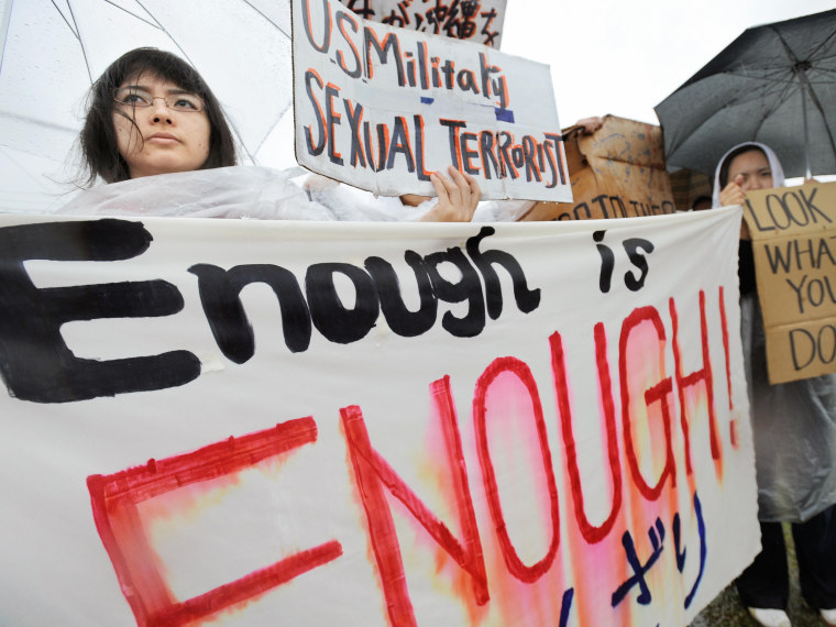 Young Japanese women hold banners during a major rally against the US military at a park in Okinawa after a string of serious misconduct by its soldiers including alleged rapes in the Japan's southern island province on March 23, 2008. More than 6,000...