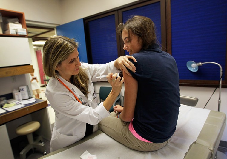 University of Miami pediatrician Judith L. Schaechter, M.D. (L) gives an HPV vaccination to a 13-year-old girl in her office at the Miller School of Medicine on September 21, 2011 in Miami, Florida. (Photo by Joe Raedle/Getty Images)