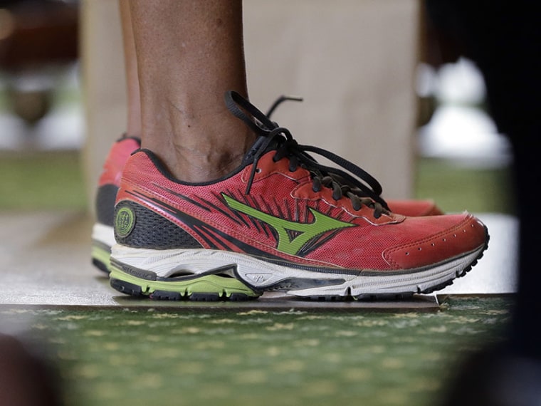 Sen. Wendy Davis, D-Fort Worth, wears tennis shoes in place of her dress shoes as she begins a one-woman filibuster in an effort to kill an abortion bill, Tuesday, June 25, 2013, in Austin, Texas. (Photo by Eric Gay/AP)