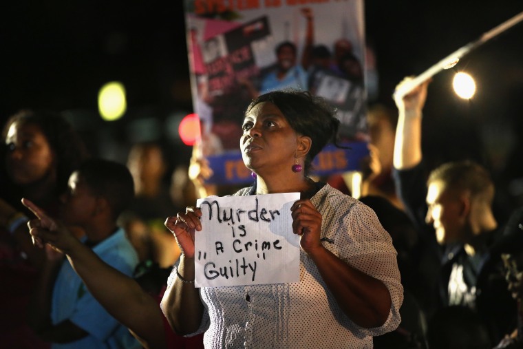 SANFORD, FL - JULY 13:  Supporters of Trayvon Martin wait in front of the Seminole County Criminal Justice Center for the verdict to be announced in the George Zimmerman murder trial on July 13, 2013 in Sanford, Florida. The jury found Zimmerman, a...