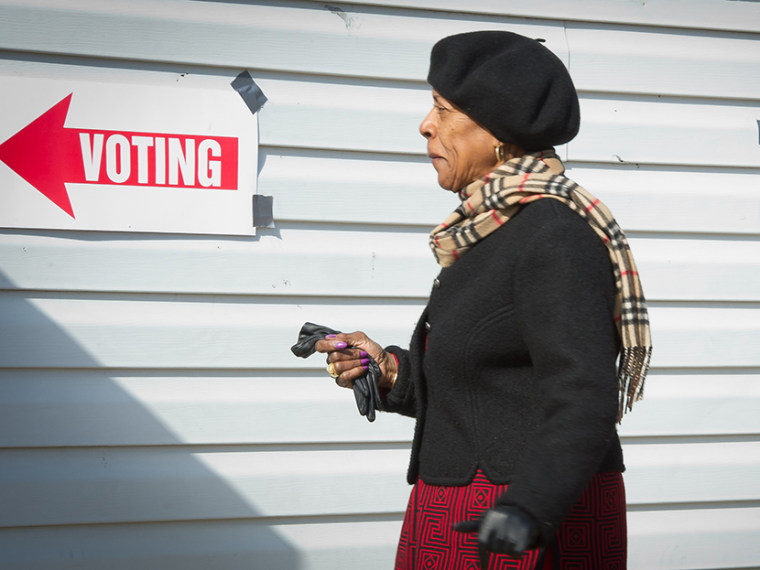 A voter walks toward the polling station to cast her ballot at the Nativity's \"Don Bosco\" youth center in Washington, DC on November 6, 2012. (Photo by Mladen Antonov/AFP/Getty Image)