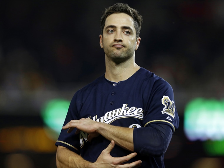 In this Sept. 21, 2012 file photo, Milwaukee Brewers Ryan Braun holds his elbow after missing a swing during a baseball game against the Washington Nationals at Nationals Park, in Washington. (Photo by Jacquelyn Martin/AP)