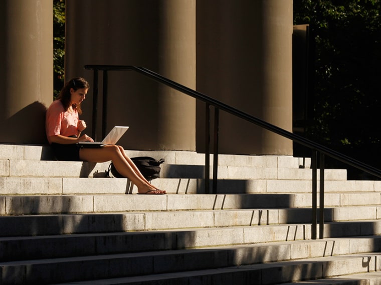 A student uses her laptop computer on the steps to Memorial Church at Harvard University in Cambridge, Massachusetts September 21, 2009.   (Photo by Brian Snyder/Reuters)