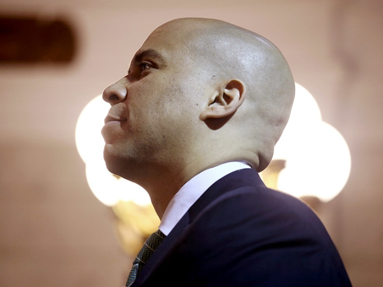 Newark Mayor Cory Booker stands for the presentation of the colors at the Newark City Hall on May 8, 2013 in Newark, New Jersey.   (Photo by John Moore/Getty Images)