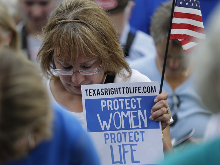 Supporters of an abortion bill pray during an anti-abortion rally at the Texas Capitol, Monday, July 8, 2013, in Austin, Texas. (Photo by Eric Gay/AP)