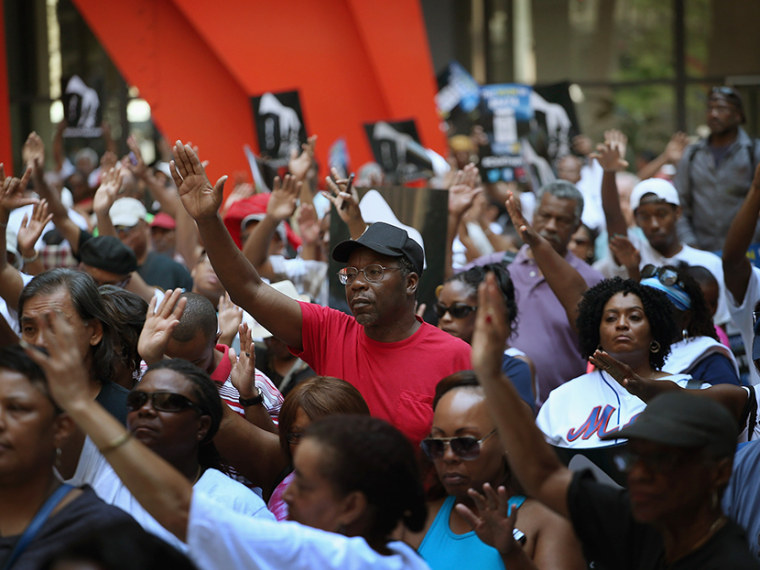 Demonstrators attend a \"Justice For Trayvon\" rally at Federal Plaza in the Loop July 20, 2013 in Chicago, Illinois.  (Photo by Scott Olson/Getty Images)