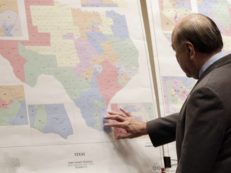 In this May 30, 2013 file photo, Texas state Sen. Juan \"Chuy\" Hinojosa looks at maps on display prior to a Senate Redistricting committee hearing, in Austin, Texas.  (Photo by Eric Gay/AP)