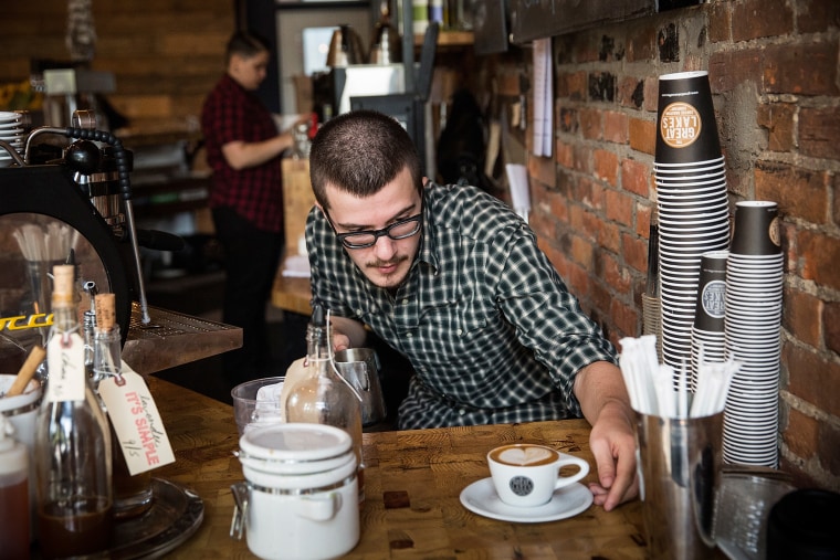 A barista at Great Lakes Coffee Roasting Company, prepares a latte over Labor Day in Detroit.