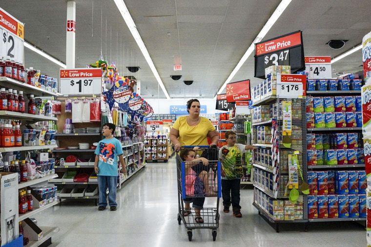 A mother and her children shop for groceries at the local Walmart in the outskirts of Harlan, Harlan, KY.