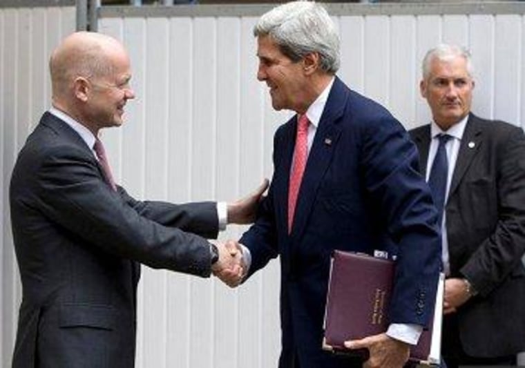 British Foreign Secretary William Hague greets Secretary of State John Kerry in London this morning.