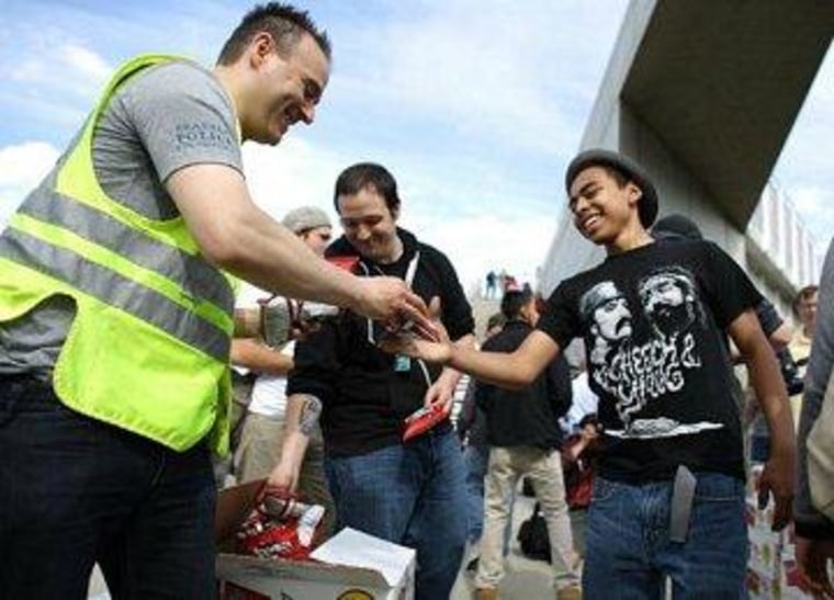 Seattle Police Department spokesman Sgt. Sean Whitcomb hands out bags of Doritos with a sticker that spells out rules for marijuana users during Seattle's annual Hempfest.