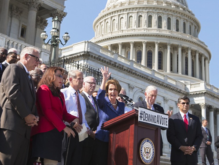 House Democrats rally behind Minority Leader Nancy Pelosi, at the Capitol in Washington, Wednesday, Oct. 2, 2013.