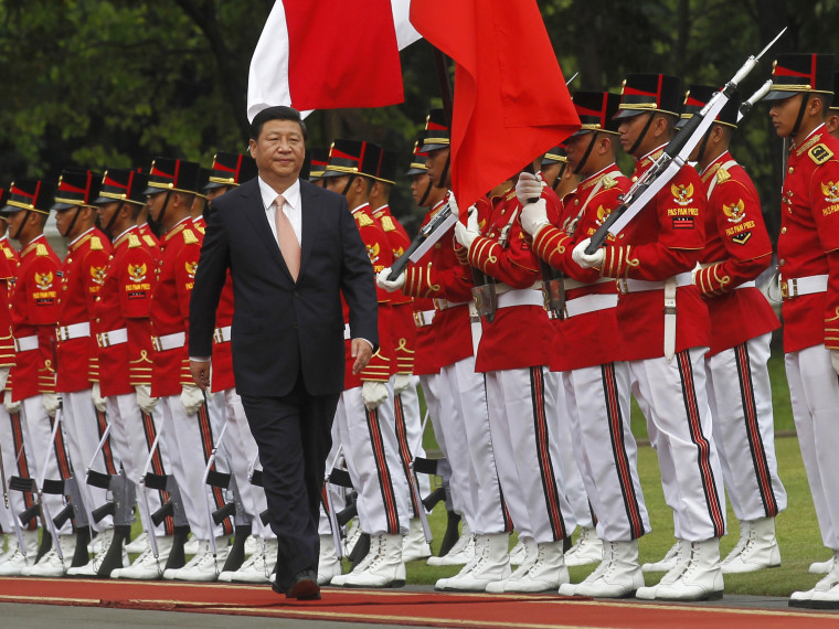China's President Xi Jinping walks during a welcoming ceremony at the Presidential Palace in Jakarta October 2, 2013.