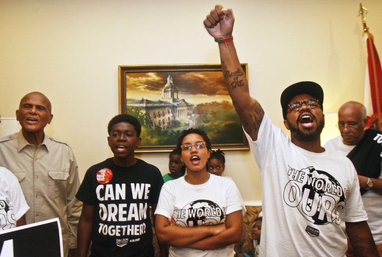 Dream Defenders Executive Director Phillip Agnew raises his fist as he leads a chant calling for a special session Friday, July 26, 2013 in the Capitol in Tallahassee, Florida.