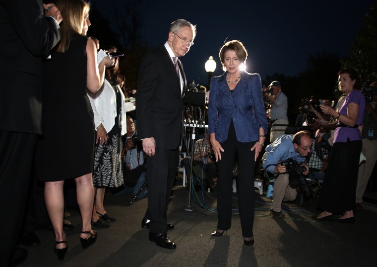 U.S. Senate Majority Leader Sen. Harry Reid (D-NV) (L) and House Minority Leader Rep. Nancy Pelosi (D-CA) (R) leave after a meeting with President Barack Obama October 2, 2013 at the White House in Washington, DC.