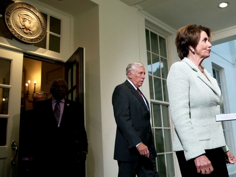 House Minority Leader Nancy Pelosi (D-CA) (R) leaves the White House with Rep. Steny Hoyer (D-MD) following a meeting between U.S. Presiden Barack Obama and members of the House Democratic leadership October 9, 2013 in Washington, DC.