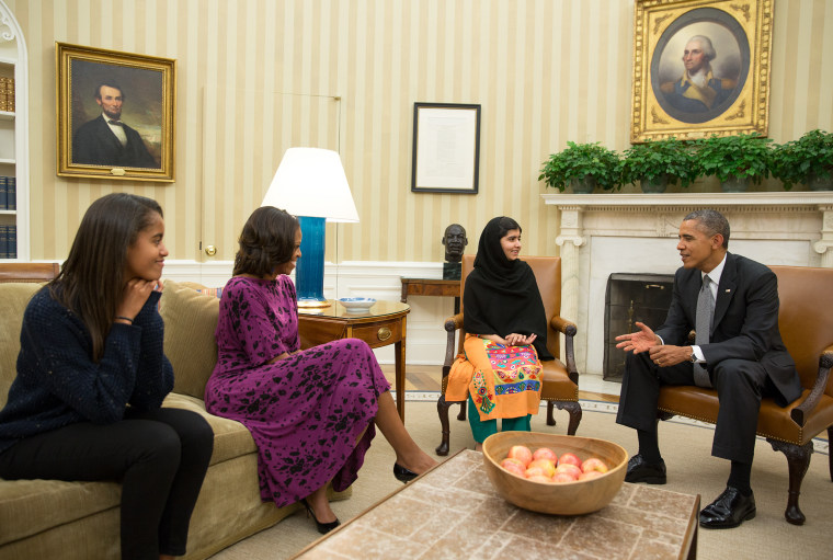 President Barack Obama, First Lady Michelle Obama, and their daughter Malia meet with Malala Yousafzai, the young Pakistani schoolgirl who was shot in the head by the Taliban a year ago, in the Oval Office, Oct. 11, 2013.