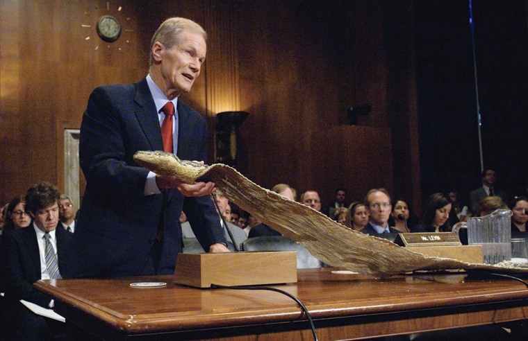 In this photograph provided by the U.S. Senate, Sen. Bill Nelson, D-Fla., during a Wednesday, July 8, 2009 hearing on Capitol Hill, holds the skin of a 16...