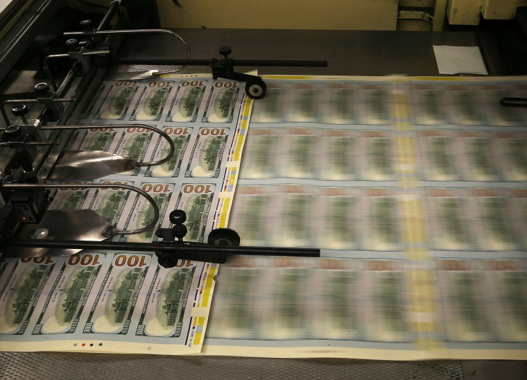 Newly redesigned $100 notes are printed at the Bureau of Engraving and Printing on May 20, 2013 in Washington, DC.