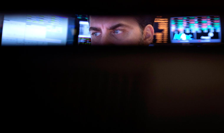 Trader checks his screens on the floor of the New York Stock Exchange in New York