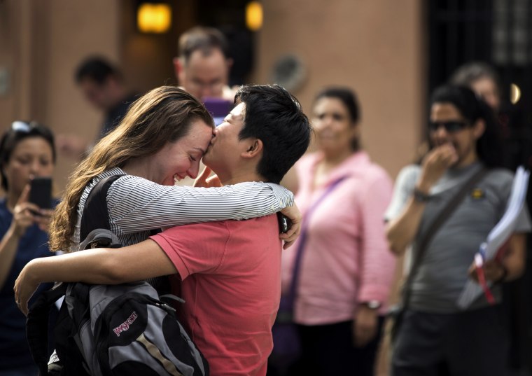 Xingha Shang and Susan Stoever embrace as they join a crowd celebrating the U.S. Supreme Court ruling against the Defense of Marriage Act, in New York