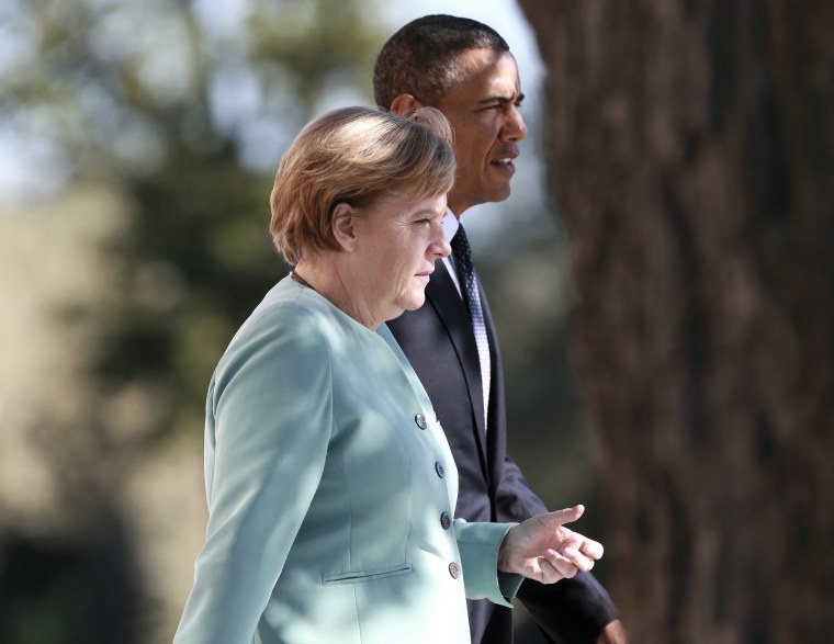 German Chancellor Merkel and U.S. President Obama walk together during the family picture event during the G20 summit in St.Petersburg