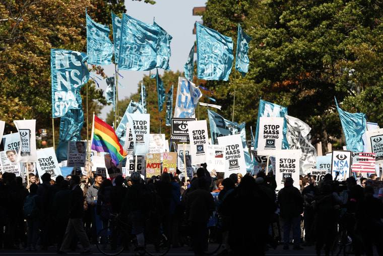 Demonstrators march through Washington towards the U.S. Capitol to rally and demand that the U.S. Congress investigate the National Security Agency's mass surveillance programs Saturday, Oct. 26, 2013.