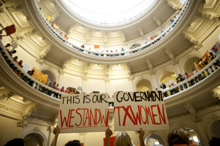 In this July 12, 2013 file photo, abortion rights supporters rally on the floor of the State Capitol rotunda in Austin, Texas.
