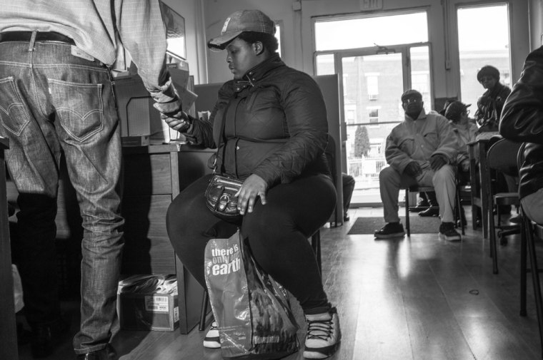 People walk in from Fulton Street and register their information in the Bed-Stuy Campaign Against Hunger office.