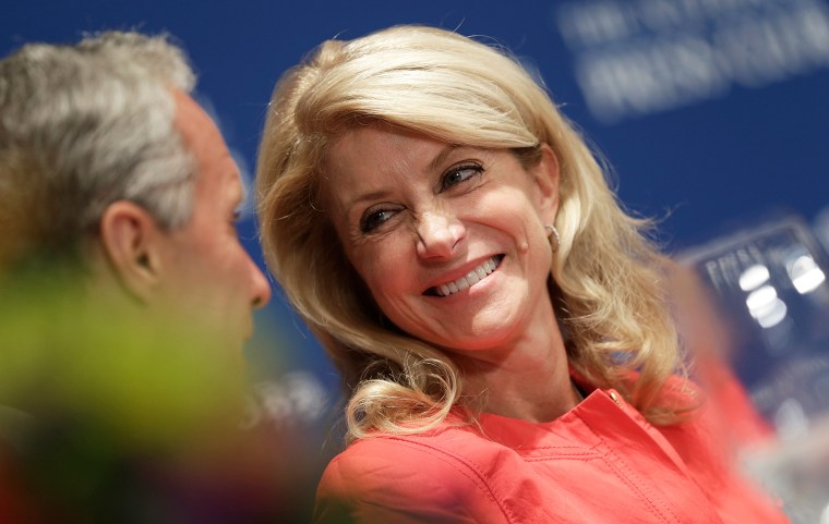Texas State Sen. Wendy Davis talks with guests at the head table before speaking at the National Press Club August 5, 2013 in Washington, DC.