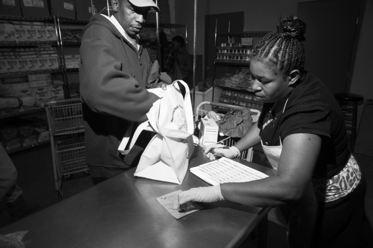 Winsome Stoner, an employee of the Bed-Stuy Campaign Against Hunger, helps with refrigerated items at the pantry's location in Brooklyn, New York on October 25, 2013.