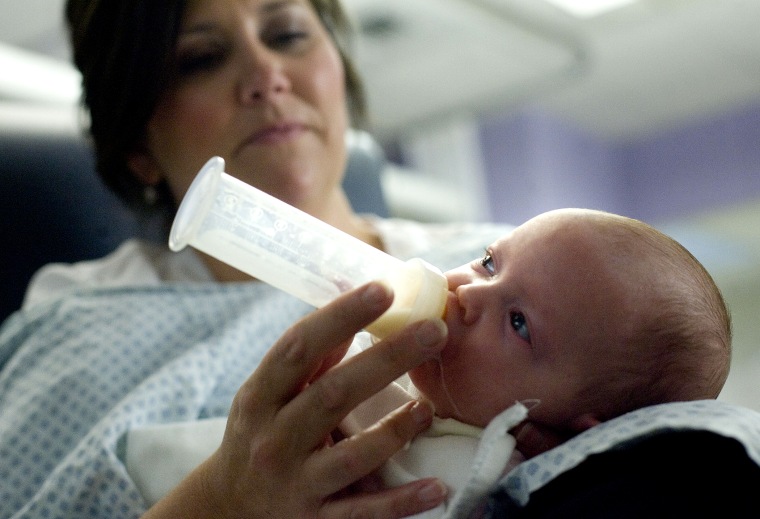 A newborn who was born prematurely, is fed by Jamie Menendez, R.N., in the Newborn Intensive Care Unit at the University of Utah Medical Center in Salt Lake City on Aug. 17, 2012.