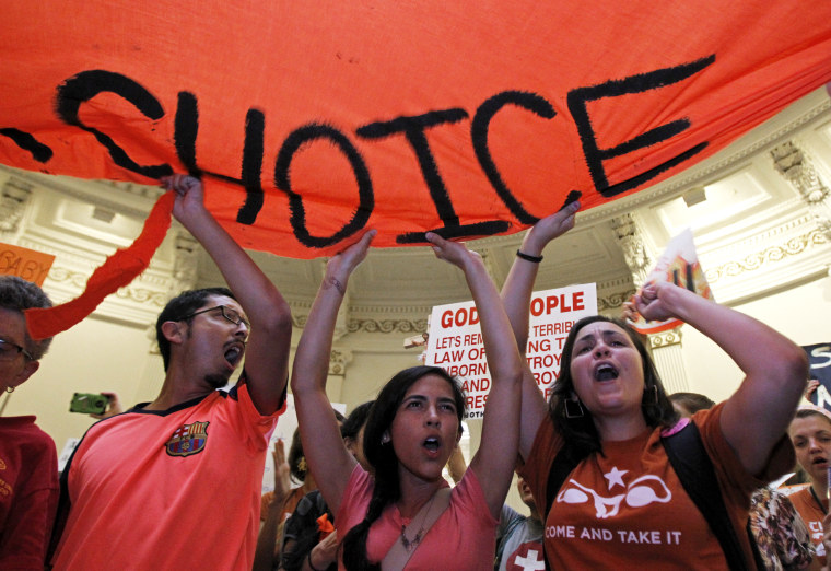 Protesters rally in the rotunda of the State Capitol as the state Senate meets to consider legislation restricting abortion rights in Austin, Texas July 12, 2013.