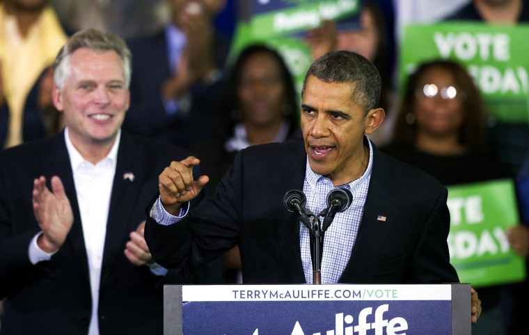 President Barack Obama speaks at a campaign rally with supporters for Virginia Democratic gubernatorial candidate Terry McAuliffe, right, at Washington Lee High School in Arlington, Va., Sunday, Nov. 3, 2013.