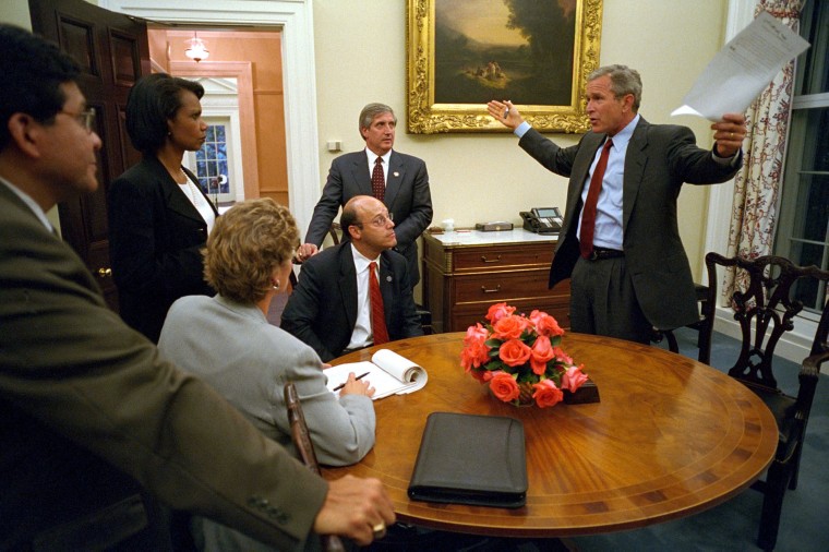 Bush White House Chief of Staff Andy Card listens with other members of the administration to President George W. Bush at The White House prior to his address to the nation about the terrorist attacks on the U.S., September 11, 2001.
