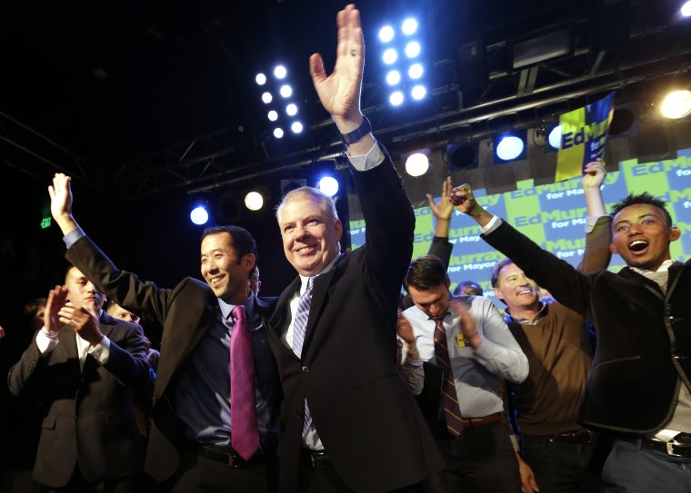 Seattle mayoral candidate state Sen. Ed Murray waves with his husband at an election night party Tuesday, Nov. 5, 2013, in Seattle.