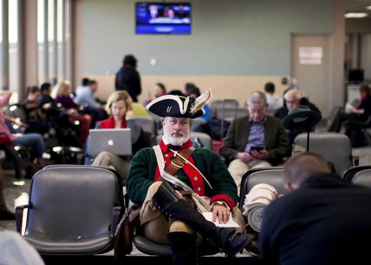 Tea party supporter William Temple sits in the Des Moines Airport, Wednesday, Jan. 4, 2012, in Iowa.