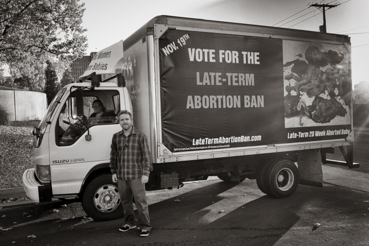 Bud Shaver and his wife Tara in the “Truth Truck” outside the women's clinic Southwestern women's Options in downtown Albuquerque.