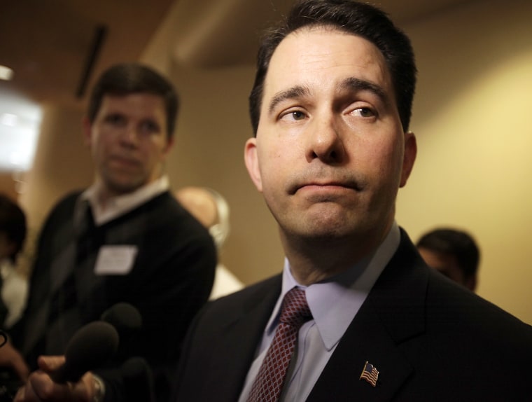 Wisconsin Gov. Scott Walker listens to a question while speaking with media about his proposed reforms to Medicaid, unemployment compensation, and food stamps, at Business Day in Madison, Wis. on Feb. 13, 2013.
