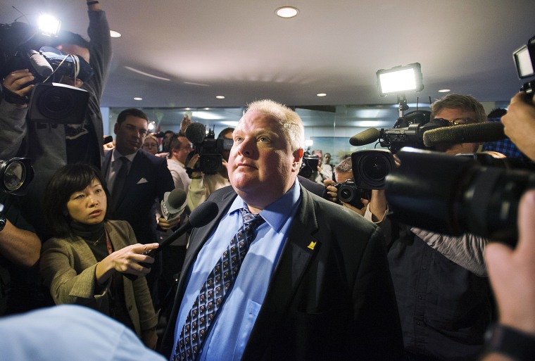 Toronto Mayor Rob Ford stands amid the media at City Hall after City Council some management powers on Nov.15, 2013 in Toronto, Canada.