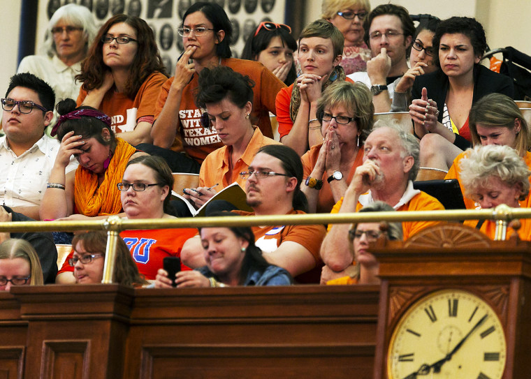 Protesters react during a debate on abortion held at the State Capitol in Austin, TX, June 23, 2013.