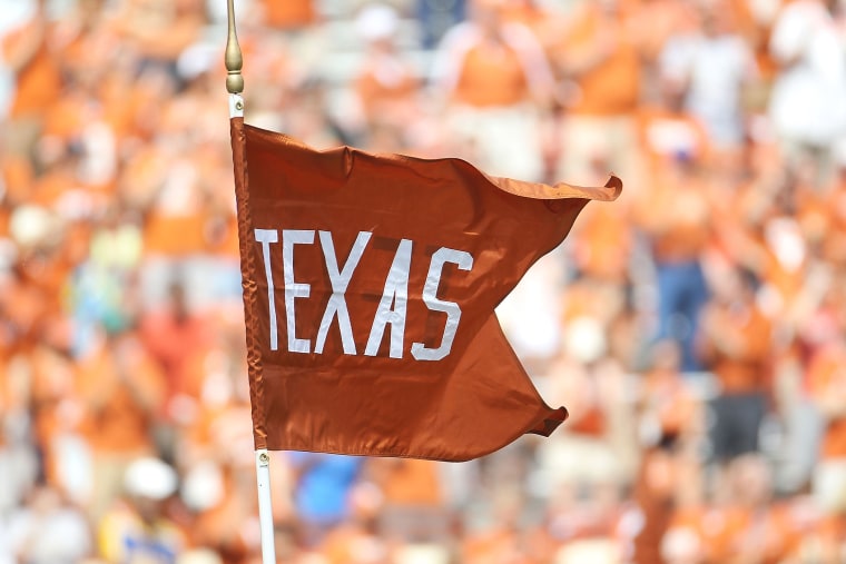 A flag for the Texas Longhorns waves at the Darrell K Royal-Texas Memorial Stadium.