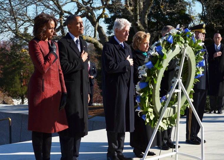 US President Barack Obama and Michelle Obama stand with the Clintons at a wreath-laying ceremony in honor of the late John F. Kennedy in Arlington, Virginia, Nov. 20, 2013.