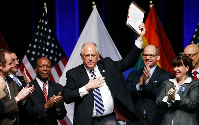 Illinois Governor Pat Quinn holds up the Religious Freedom and Marriage Fairness Act after signing it into law, Nov. 20, 2013.