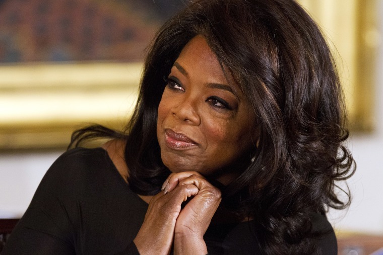 Winfrey listens in the East Room of the White House in Washington, Nov. 20, 2013.
