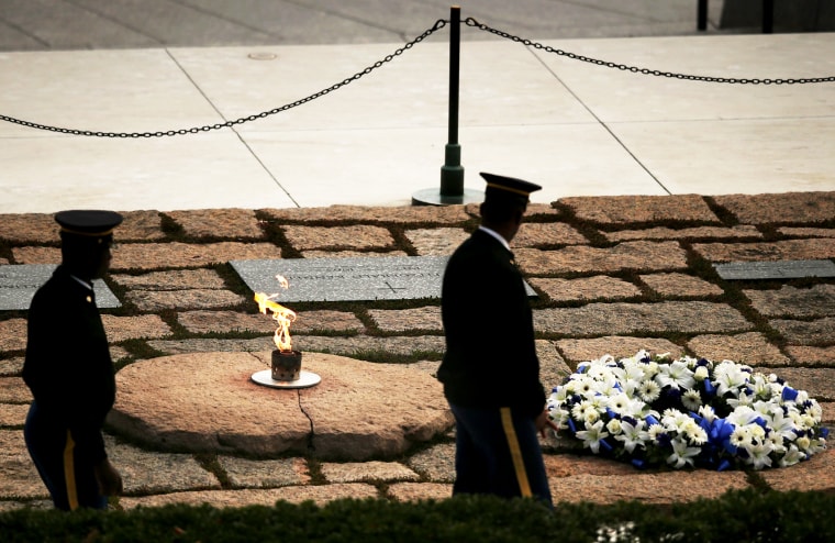 Members of the armed forces perform a walk-through at the gravesite of former U.S. President John F. Kennedy at Arlington National Cemetery, Nov. 22, 2013.