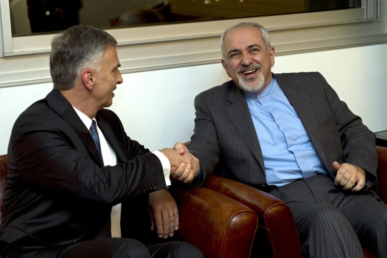 Switzerland's Foreign Minister Didier Burkhalter, left, shakes hands with Iranian Foreign Minister Mohammad-Javad Zarif, during a meeting at the Intercontinental Hotel prior to talks about Iran's nuclear programme in Geneva, Switzerland, Saturday, Nov. 23