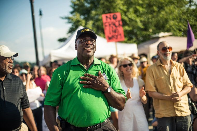 Herbert Grant cheers in support during a speech by Rev Dr. William Barber II, president of the North Carolina NAACP in Asheville, NC's Pack Square Park during Mountain Moral Monday on Aug 5, 2013.