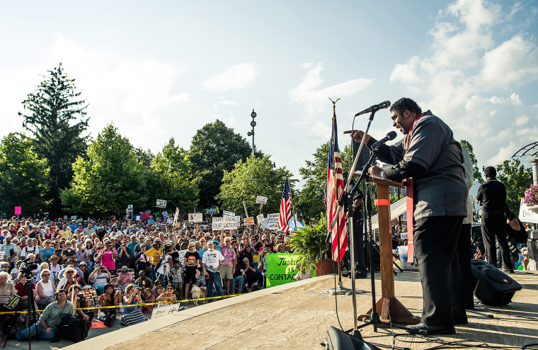 Rev. Dr. William Barber II, president of the North Carolina NAACP speaks to a crowd of thousands gathered in Asheville, NC's Pack Square Park during Mountain Moral Monday on Aug 5, 2013.