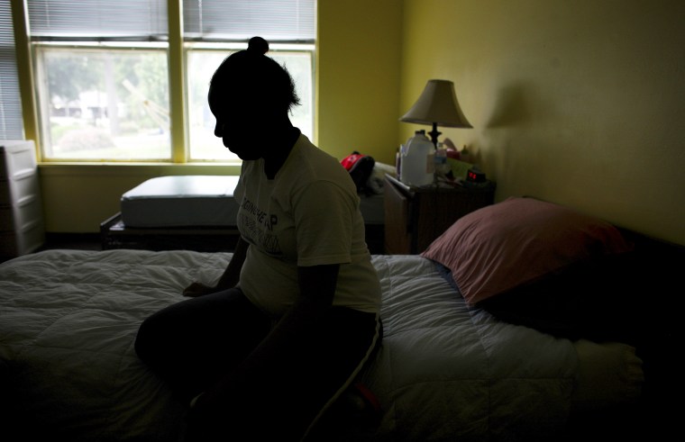 A pregnant victim of domestic violence rests in her room at Mutual Ground's shelter in Aurora, Illinois.
